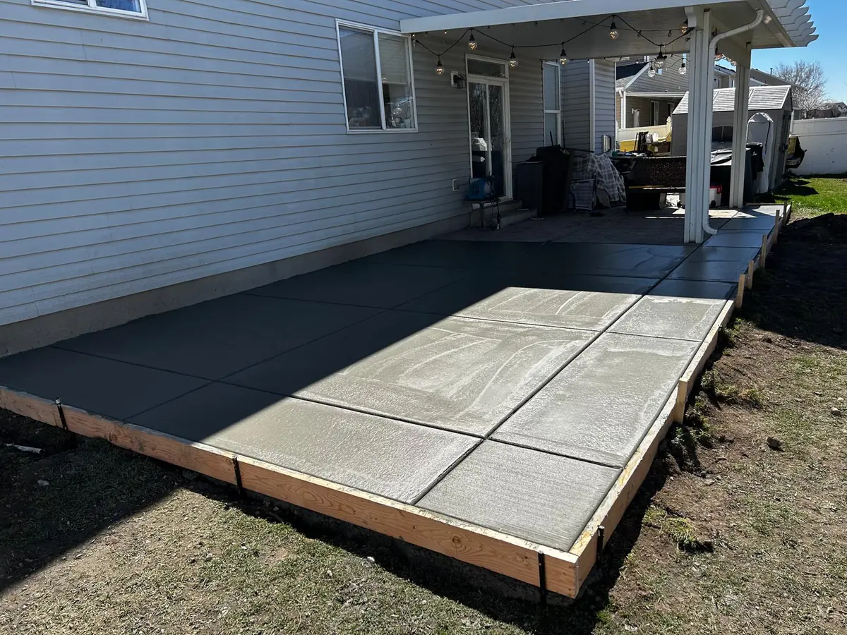 Concrete Plus backyard patio with a broom finish and rectangular control joints